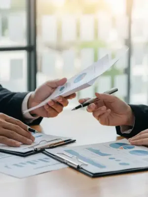 Couple analyzing 401(k) statements and financial projections for 2026 retirement planning