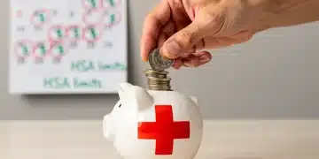Hand placing coins into a medical cross piggy bank, symbolizing 2026 HSA limits and tax-advantaged savings.